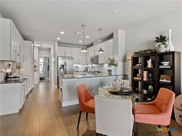 dining space with dark hardwood / wood-style floors