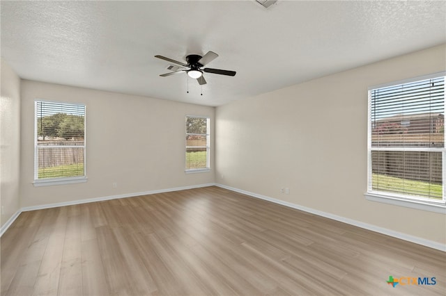 213 Springtree Pkwy, Cibolo, TX 78108 - unfurnished room featuring light wood finished floors, ceiling fan, and a textured ceiling