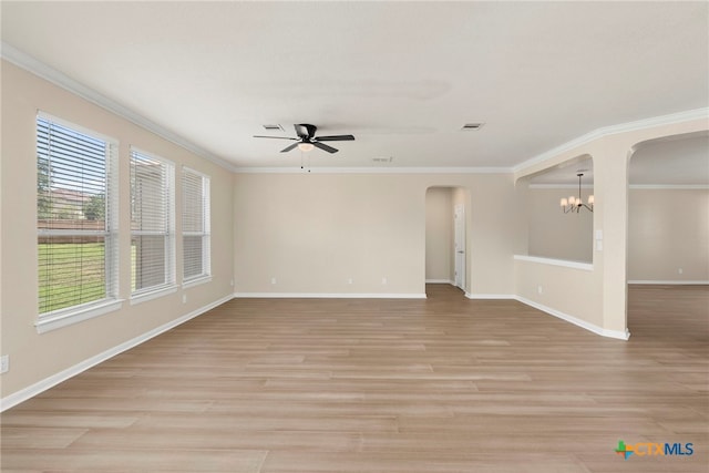 213 Springtree Pkwy, Cibolo, TX 78108 - spare room featuring arched walkways, a ceiling fan, a chandelier, ornamental molding, and light wood finished floors