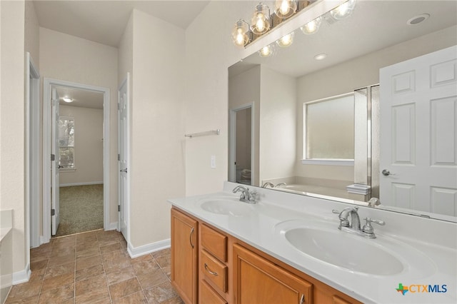 213 Springtree Pkwy, Cibolo, TX 78108 - bathroom with healthy amount of natural light, double vanity, a bath, and stone finish floors