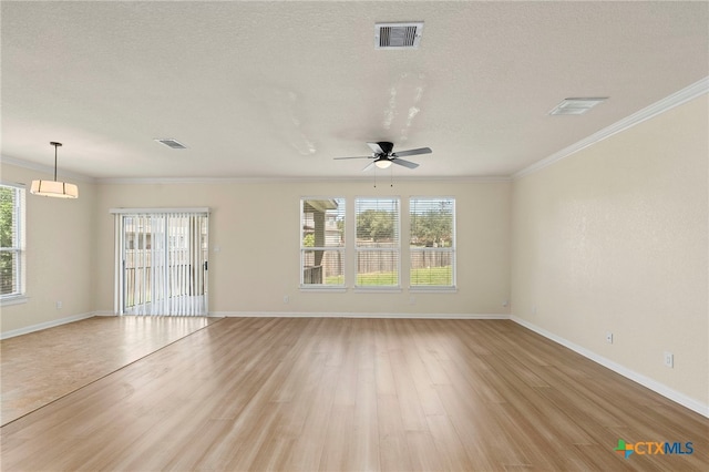 213 Springtree Pkwy, Cibolo, TX 78108 - unfurnished living room featuring crown molding, light wood-type flooring, plenty of natural light, a ceiling fan, and a textured ceiling