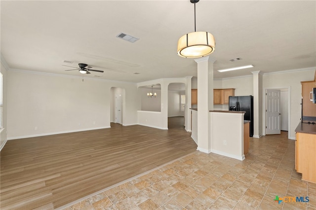 213 Springtree Pkwy, Cibolo, TX 78108 - unfurnished living room featuring a ceiling fan, decorative columns, ornamental molding, and arched walkways