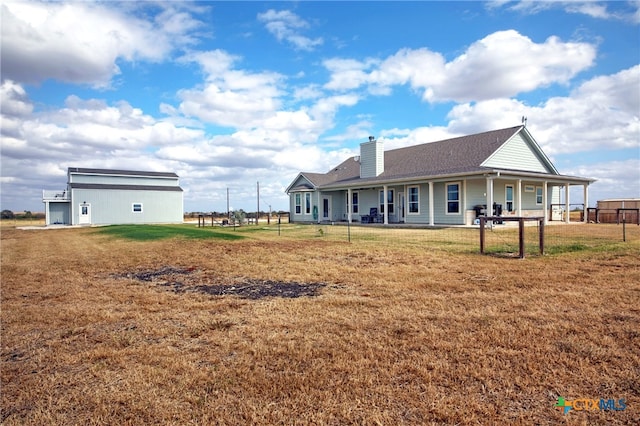 back of house with a lawn