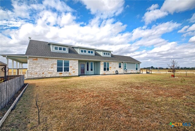 rear view of property featuring a yard