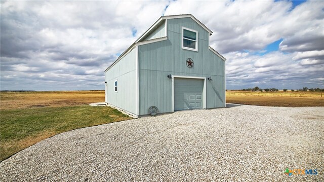 view of outbuilding featuring a garage and a rural view