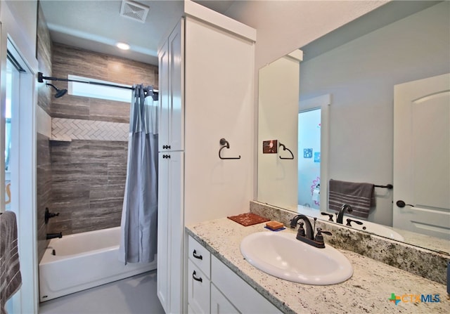 bathroom featuring vanity and shower / bathtub combination with curtain