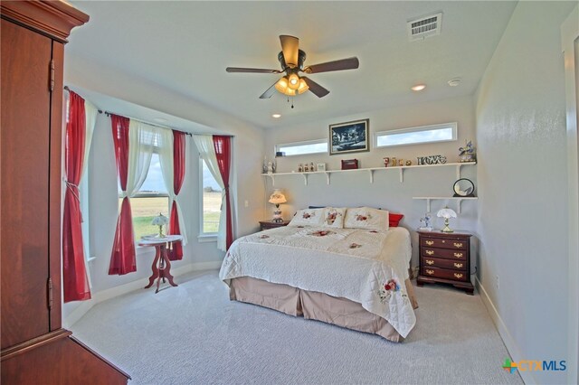 bedroom featuring light carpet and ceiling fan