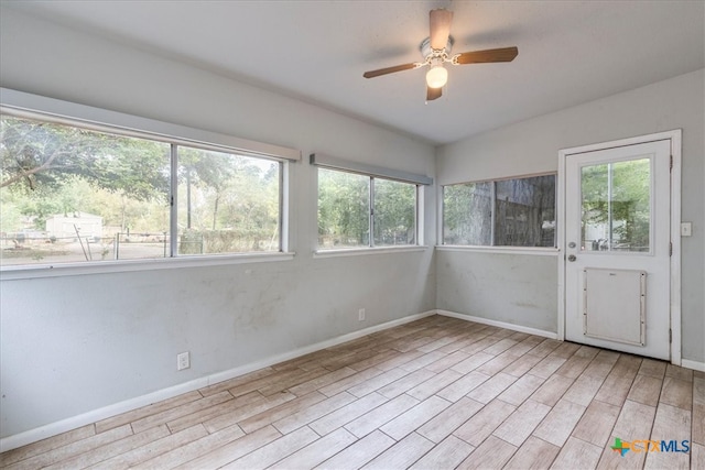 empty room featuring ceiling fan and light hardwood / wood-style flooring