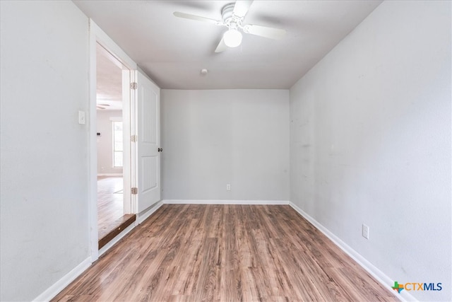 empty room with hardwood / wood-style floors and ceiling fan