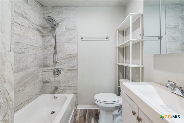 full bathroom featuring tiled shower / bath, vanity, wood-type flooring, and toilet