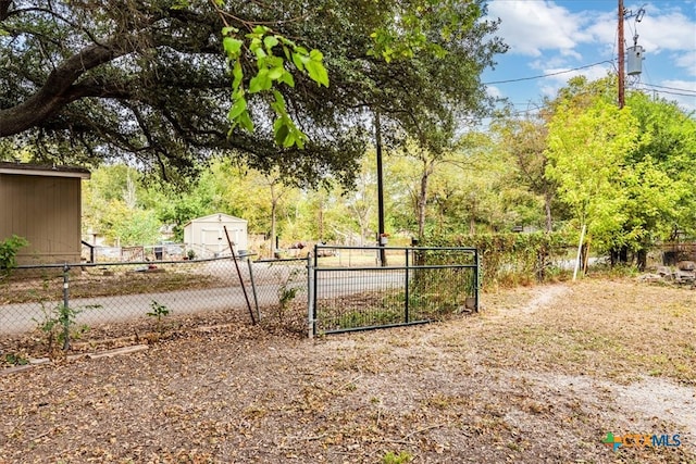 view of gate featuring a storage unit