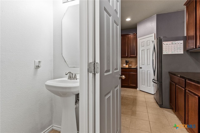 bathroom featuring decorative backsplash and tile patterned floors