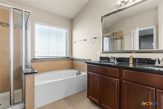 bathroom with tile patterned flooring, vanity, vaulted ceiling, and shower with separate bathtub