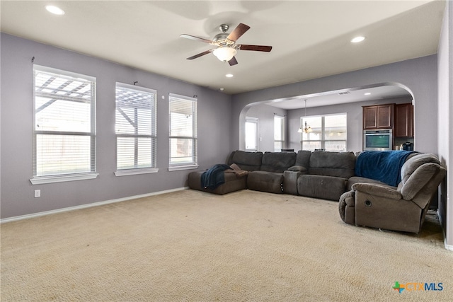 carpeted living room featuring ceiling fan