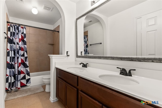 full bathroom with shower / bath combination with curtain, toilet, vanity, and tile patterned flooring