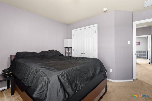 carpeted bedroom with a closet