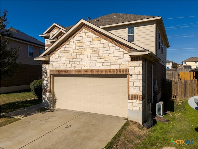 exterior space featuring a garage and ac unit