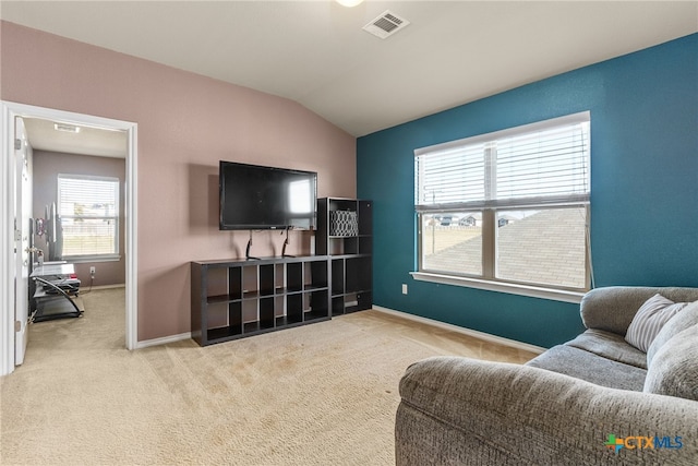 living room featuring light carpet and vaulted ceiling