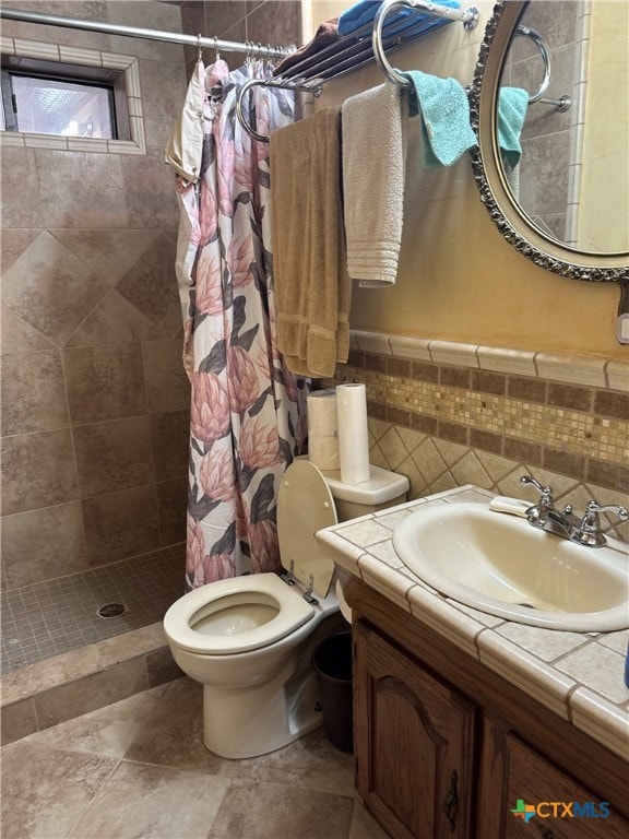 bathroom with walk in shower, vanity, toilet, and tile walls