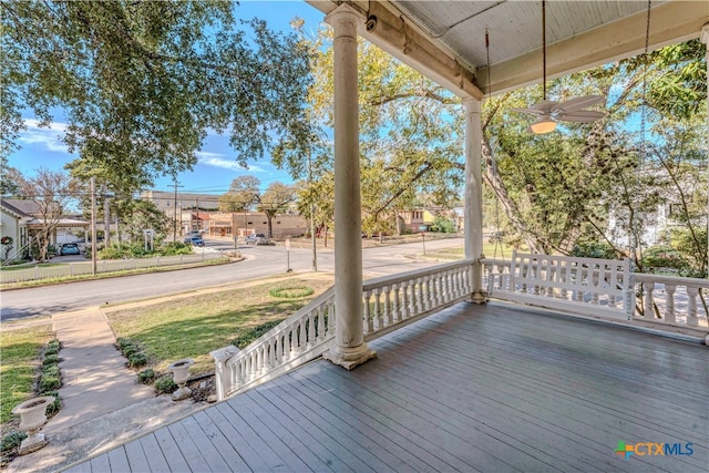 wooden terrace featuring ceiling fan and covered porch