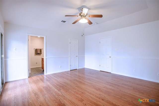 interior space featuring baseboards, ceiling fan, visible vents, and wood finished floors