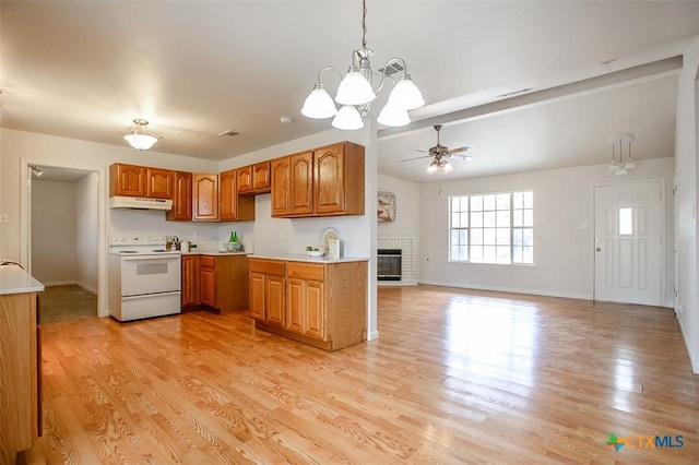 kitchen featuring light countertops, white range with electric cooktop, light wood-style flooring, and under cabinet range hood