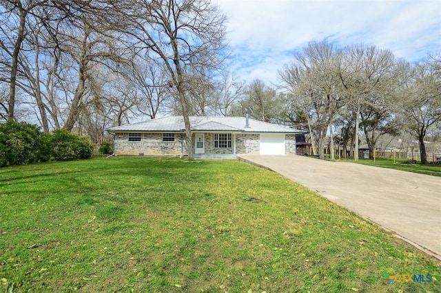 ranch-style house with driveway, stone siding, an attached garage, and a front lawn