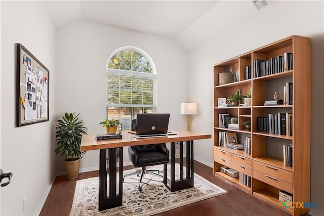 office space featuring dark wood finished floors, vaulted ceiling, visible vents, and baseboards