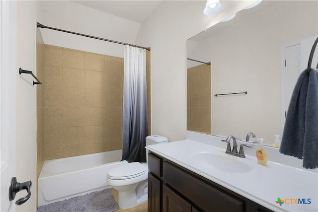 full bathroom featuring toilet, vanity, and shower / bath combo with shower curtain