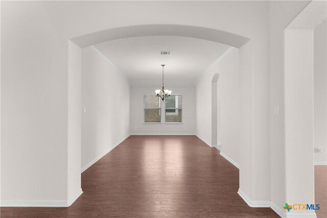 dining area with ceiling fan with notable chandelier, wood-type flooring, and ornamental molding