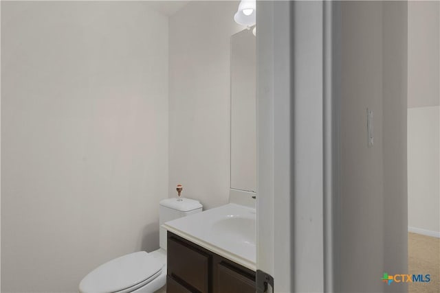 bathroom featuring toilet and vanity