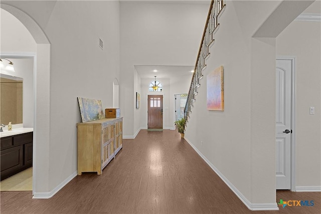 corridor with light hardwood / wood-style floors and sink