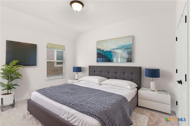 bedroom featuring carpet, lofted ceiling, and baseboards
