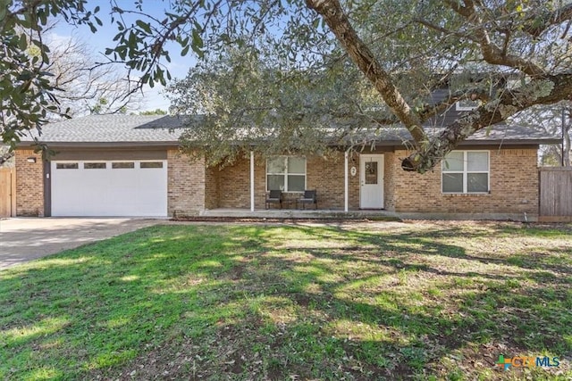 ranch-style home with a garage and a front yard