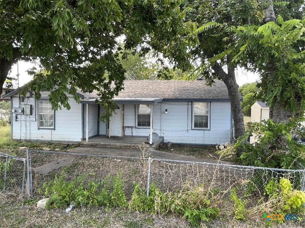 view of front of home with a shed