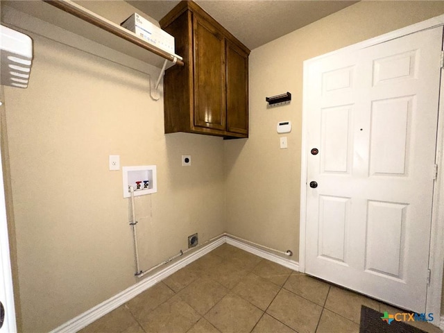 1403 Excel Dr, Killeen, TX 76542 - washroom with washer hookup, cabinet space, electric dryer hookup, gas dryer hookup, and tile patterned floors