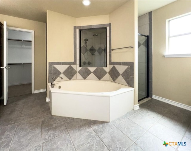 1403 Excel Dr, Killeen, TX 76542 - full bathroom with a bath, a shower stall, and a walk in closet