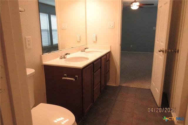 9202 Sage Valley Dr, Temple, TX 76502 - bathroom featuring toilet, double vanity, tile patterned flooring, and ceiling fan