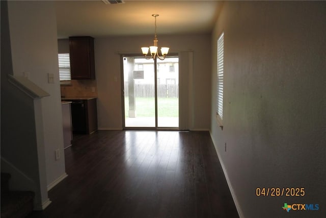 9202 Sage Valley Dr, Temple, TX 76502 - unfurnished dining area with a chandelier, dark wood-type flooring, baseboards, and stairway