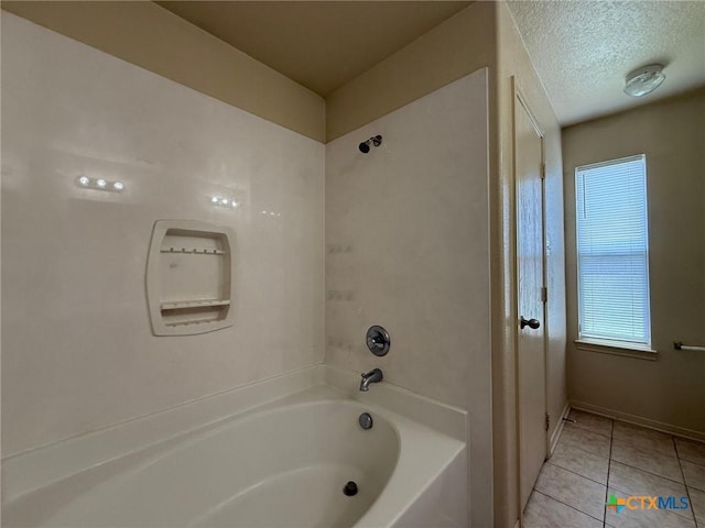 3608 Doffy Dr, Killeen, TX 76549 - bathroom featuring a textured ceiling, tile patterned flooring, and bathtub / shower combination