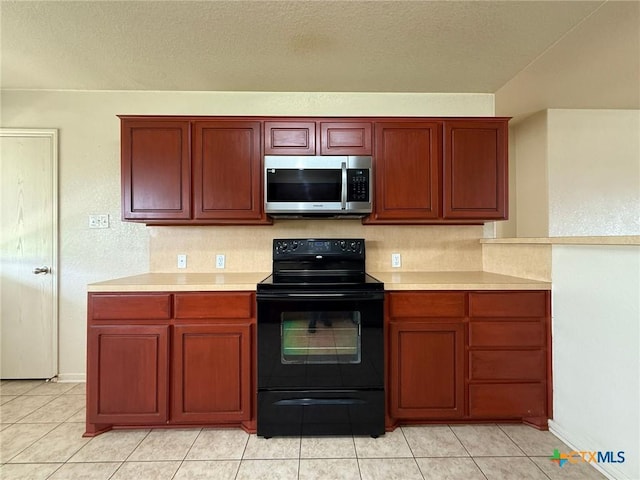 3608 Doffy Dr, Killeen, TX 76549 - kitchen featuring stainless steel microwave, light countertops, black / electric stove, and light tile patterned floors