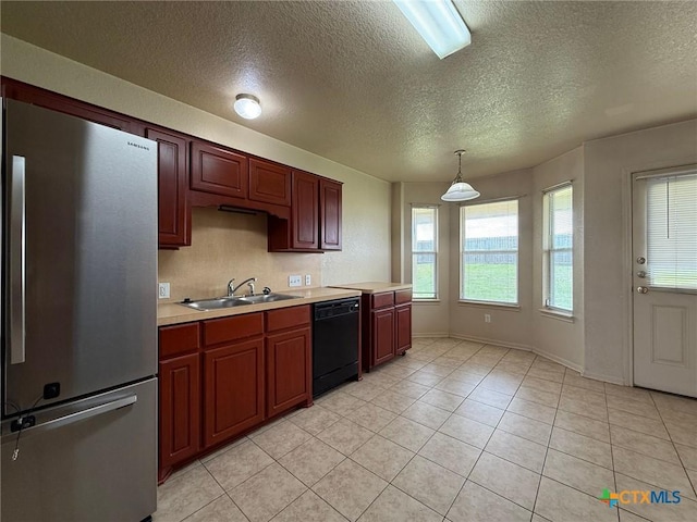 3608 Doffy Dr, Killeen, TX 76549 - kitchen featuring freestanding refrigerator, a textured ceiling, black dishwasher, a sink, and light countertops