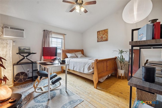 bedroom with a wall mounted AC, hardwood / wood-style floors, ceiling fan, and lofted ceiling