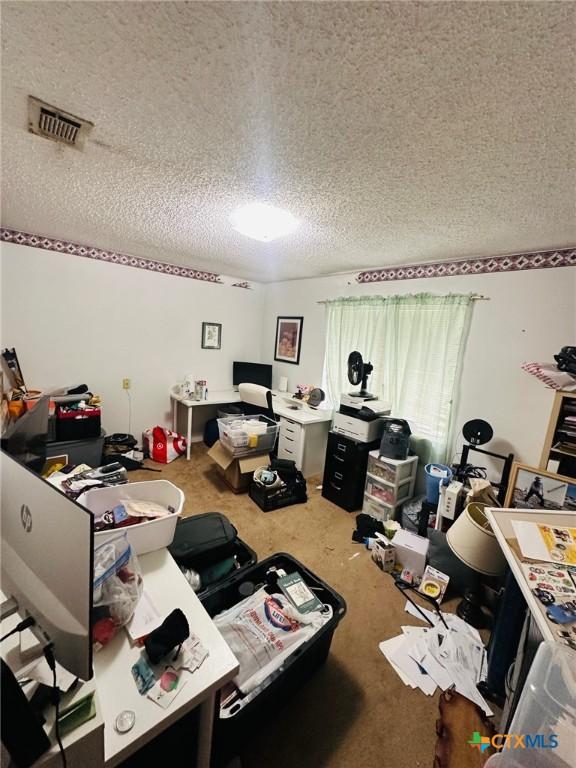 218 Monterrey Dr, Victoria, TX 77904 - carpeted home office with a textured ceiling