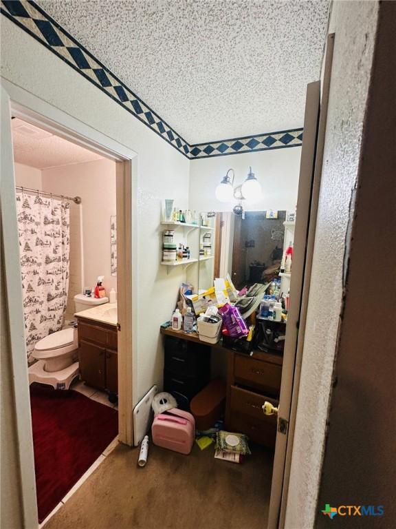 218 Monterrey Dr, Victoria, TX 77904 - full bath with vanity, toilet, a textured ceiling, and a shower with curtain