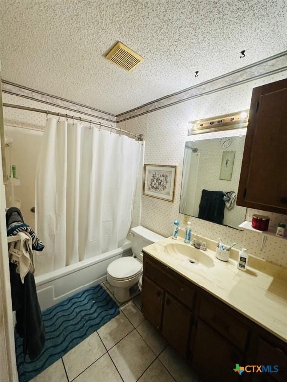 218 Monterrey Dr, Victoria, TX 77904 - bathroom with vanity, shower / bath combination with curtain, wallpapered walls, toilet, and a textured ceiling