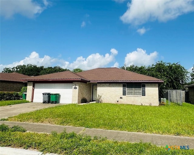 218 Monterrey Dr, Victoria, TX 77904 - ranch-style home featuring an attached garage, brick siding, and driveway