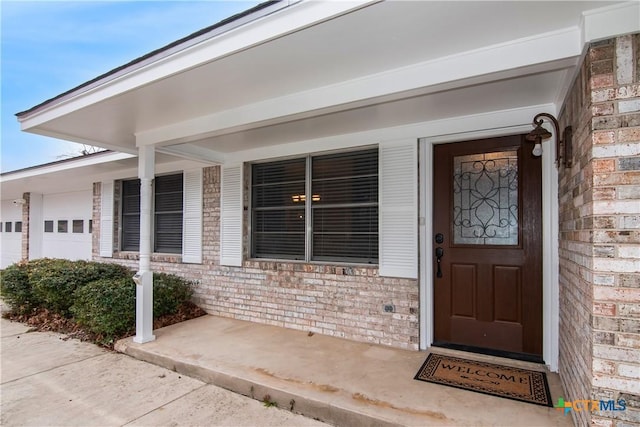 view of exterior entry featuring a porch