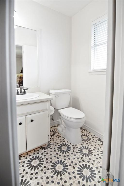 bathroom featuring toilet, tile patterned flooring, and vanity