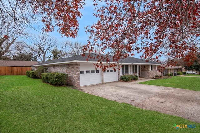 ranch-style house featuring a garage and a front lawn